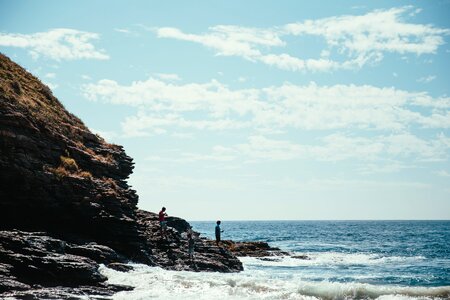 Hikers On Seaside Rocks photo