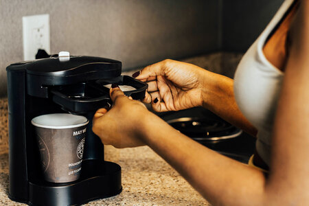 Woman making coffee photo
