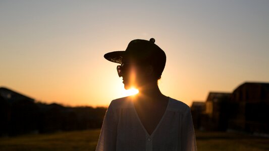 woman wearing a hat and sunglass silhouette photo