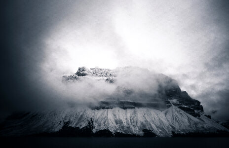 Fog over the mountaintop with snow in Banff National Park, Alberta, Canada photo