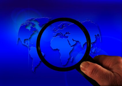 Planet magnifying glass hand