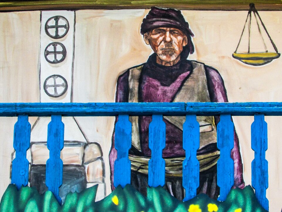 Old man traditional costume balcony