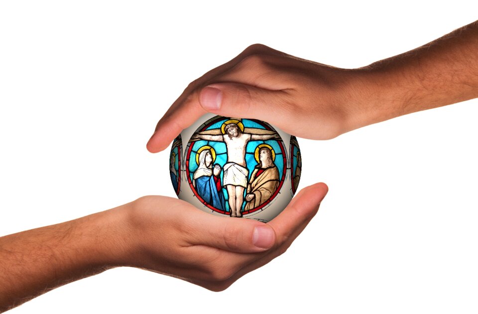 Hands protect cross