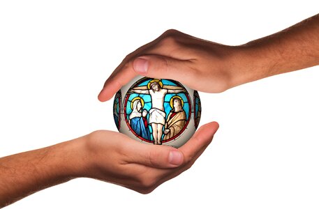 Hands protect cross