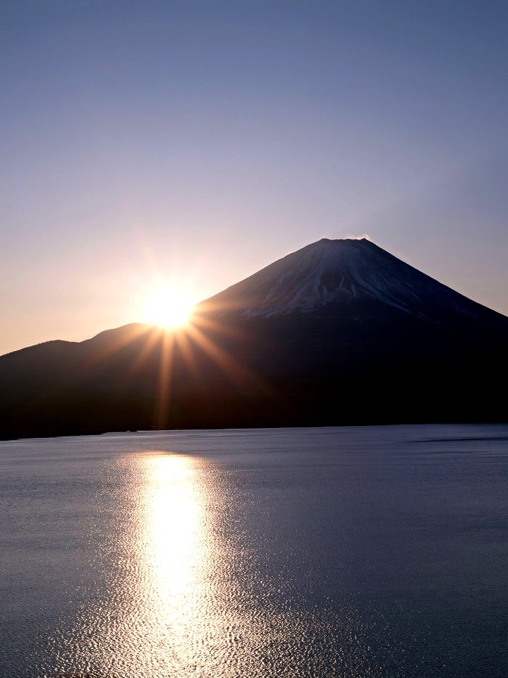 Sunset in huge mountains near lake