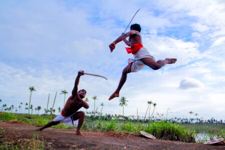 Two Man in White Shorts Fighting Using Sword photo