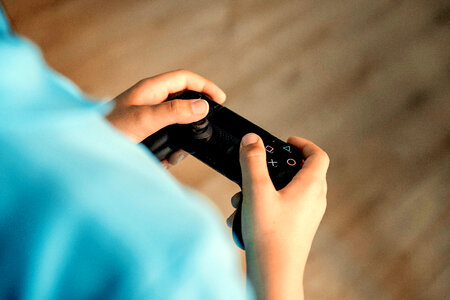 Young boy gaming and holding gamepad photo
