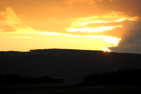 Burning sky behind mountain