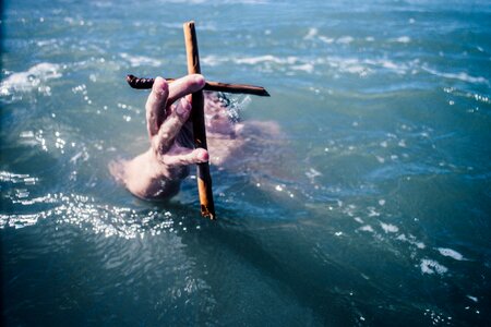 Swimmer holding a cross photo