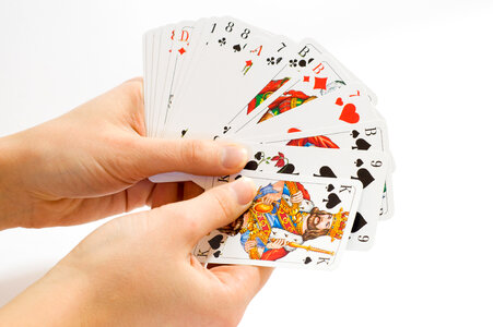Hand holding a bunch of playing cards photo