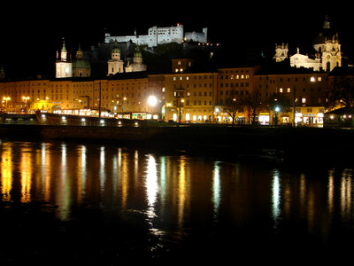 The fortress, Cathedral, and river at night in Salzburg, Austria photo