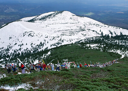 Group of skiers walks up the hill