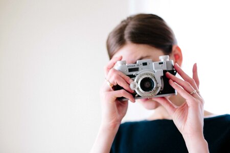 Woman with Vintage Camera in the Hands photo