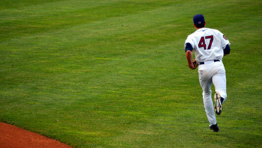baseball player running on field photo