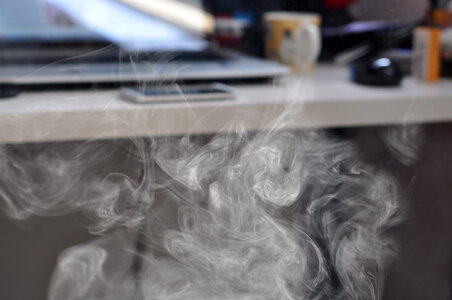 E-cig’s vapor in front of desk photo