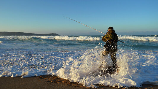 Senior man fishing at sea side photo