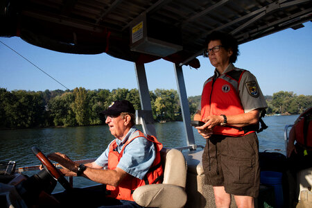 Volunteer, Richard Esker, drives a boat on the Ohio River-1