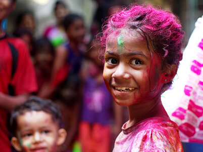 Child with paint on her in Mumbai, India photo
