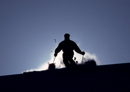 Skier on a slope at sunset