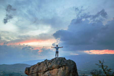 Boy standing on Mountain looking at clouds in Villa de Leyva photo