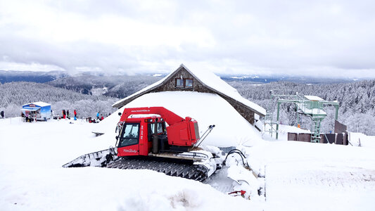 Snow covered Roof with tractor photo