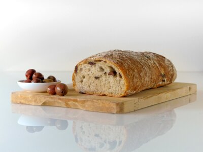 freshly baked ciabatta bread on wooden cutting board photo