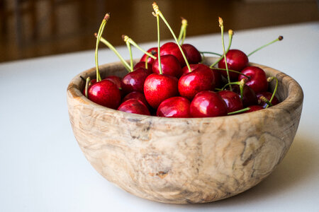 Fresh cherries in a wooden bowl photo