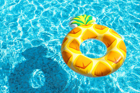 Inflatable ring floating in pool on sunny day photo