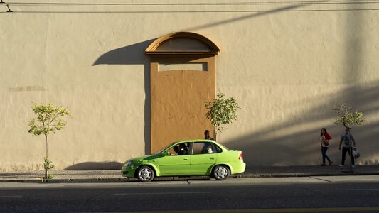 Green Car Passes Wall photo