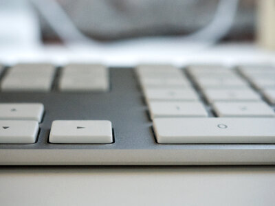 Keyboard on White Desk photo