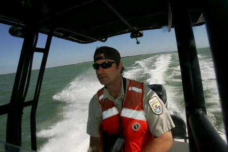Service employee operates refuge boat