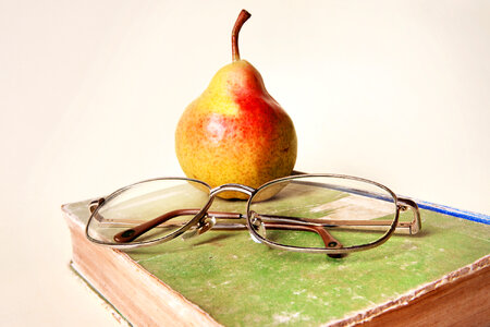 book, glasses and pear photo
