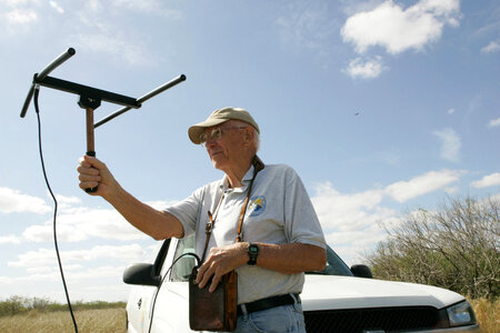 Service volunteer holding tracking device