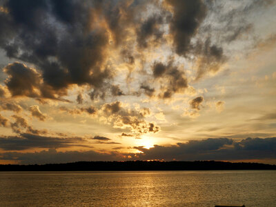 Sunset with sky and clouds over the water photo