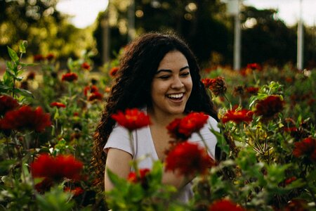 Beautiful young woman in rose garden photo