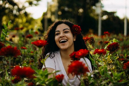 Beautiful young woman in rose garden photo