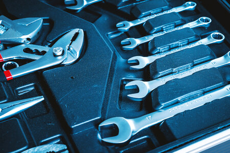 Tools and black toolbox. Many wrench and other tools in toolkit sets photo