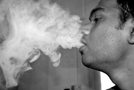Guy Blowing Smoke Hookah photo