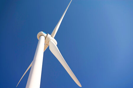 Wind turbine against a blue sky photo