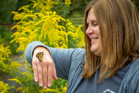 Woman holding monarch butterfly on hand-3