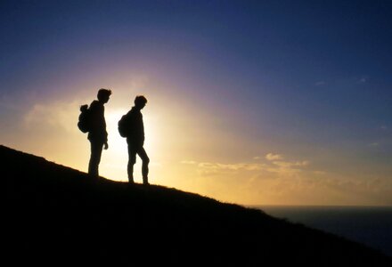 Silhouette of people hiking on mountain photo