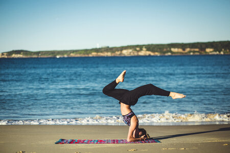 Young Woman Does Yoga on the Beach photo