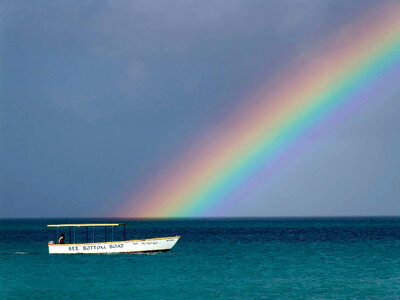 Rainbow over the ocean with a boat in Jamaica