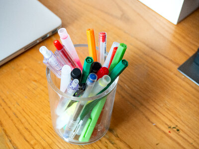 Pens and Laptop on Desk photo