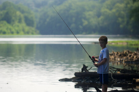 Young boy with fishing pole in hand