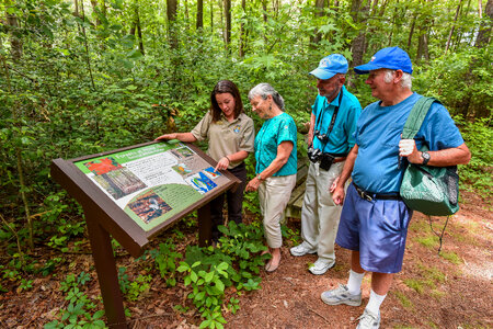 FWS Visitor services staffer shows interpretive panel to visitors-2