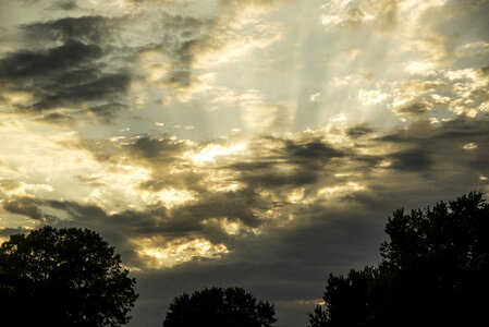 Dramatic Skies at sunset with clouds and sun rays photo