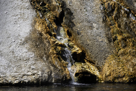 Hot water flowing down from the springs photo