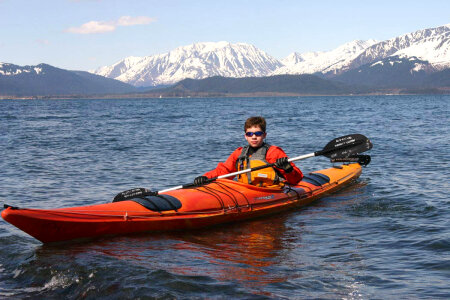 Boy paddling in a kayak photo