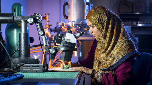female scientist use microscope in the laboratory photo